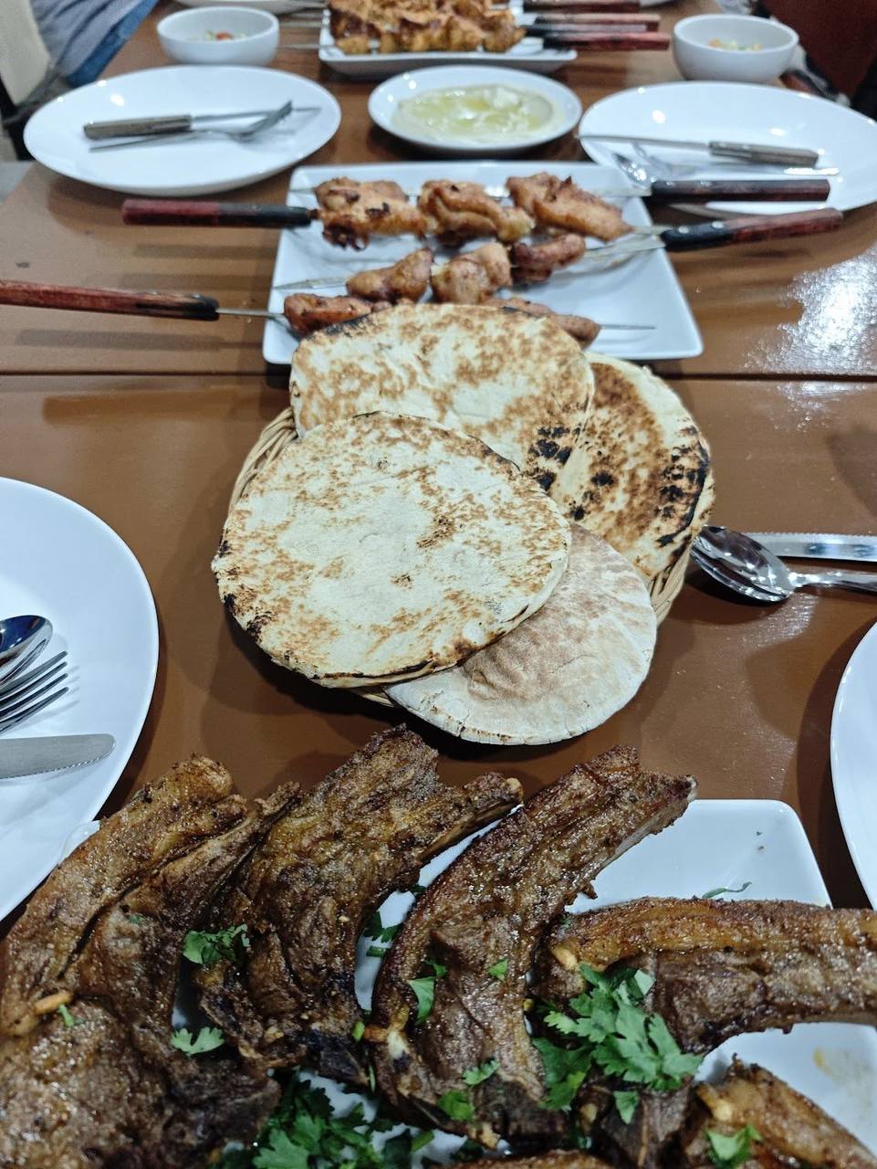 Mixed grilled meats and fresh bread on the table